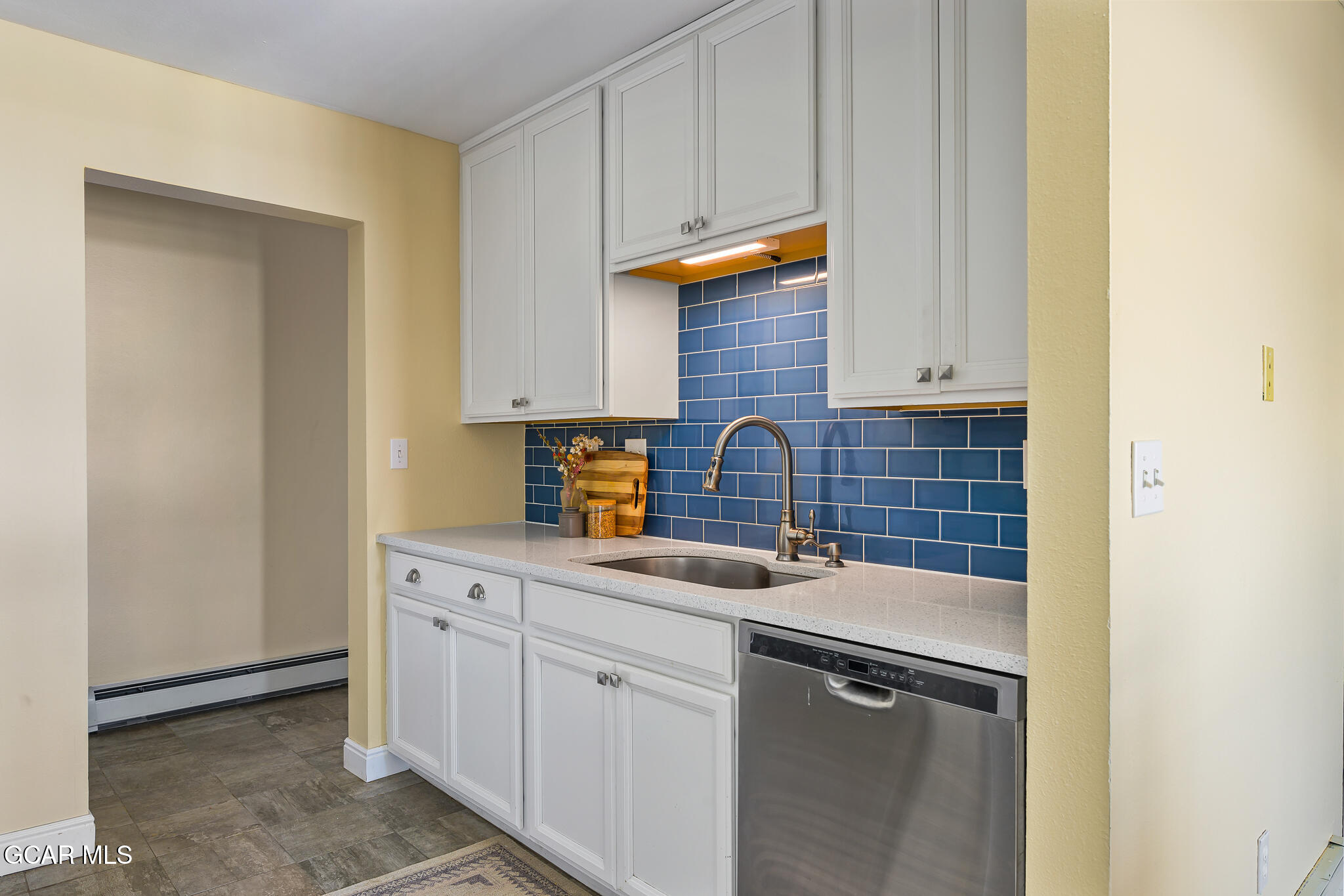 a kitchen with stainless steel appliances granite countertop a sink and cabinets