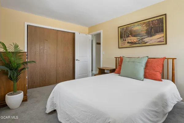 a bedroom with a large bed and a window