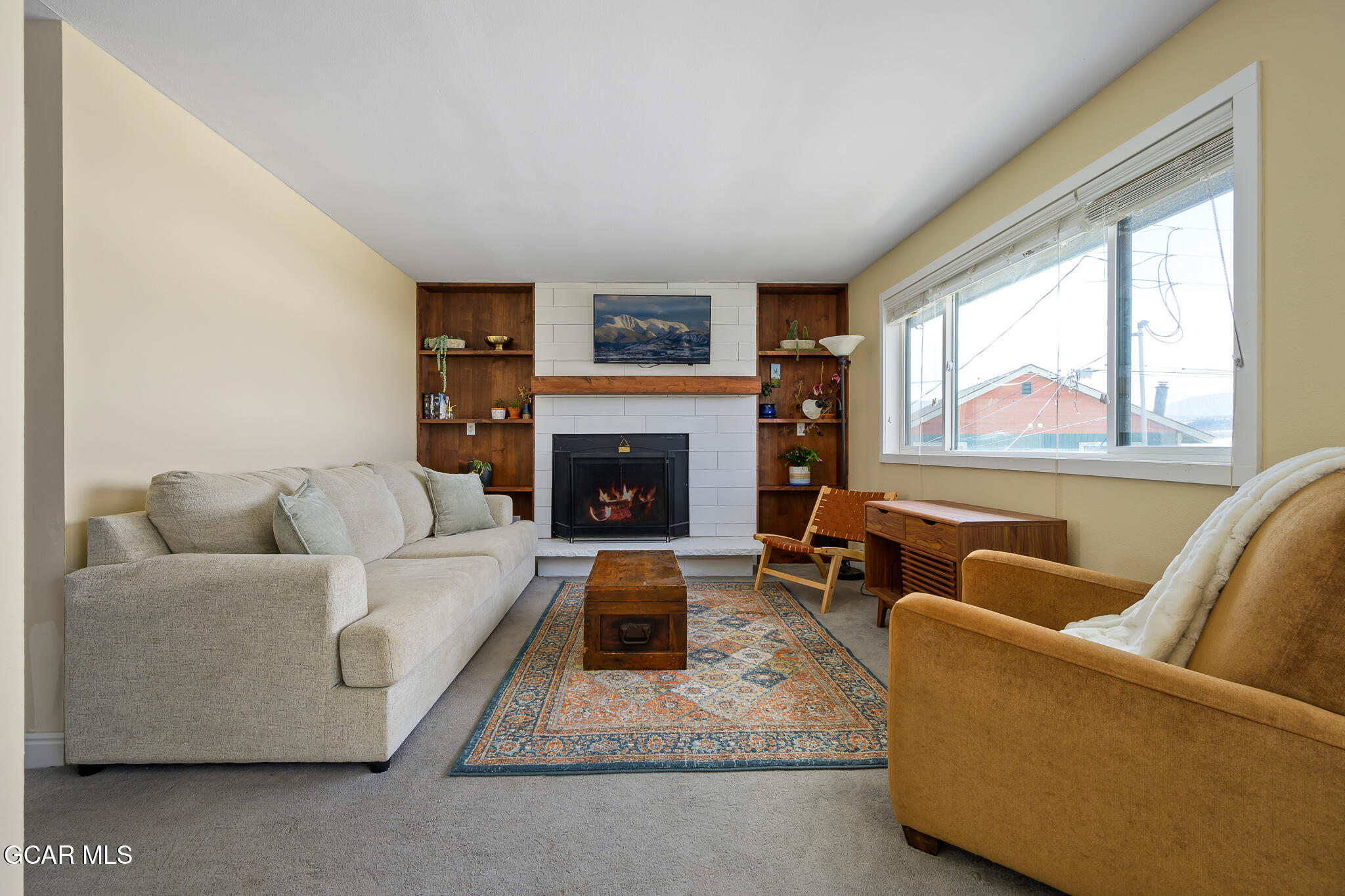 110 Carriage Road, Unit 8 Fraser, CO 80442 - Photo 7 of 36 a living room with furniture and a fireplace