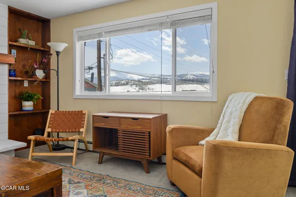 a living room with furniture a lamp and a window