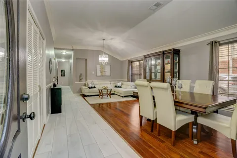 a living room with furniture a wooden floor and a large window