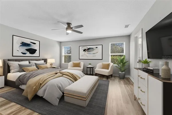 a bedroom with two beds and a flat screen tv