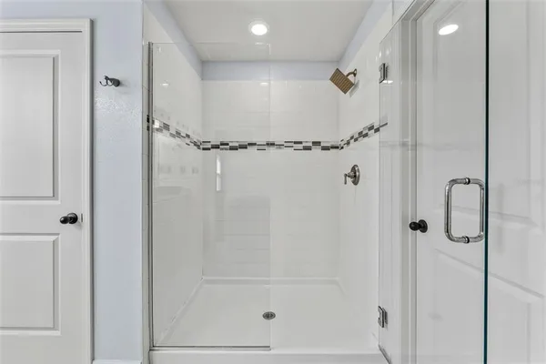 a bathroom with a glass shower door
