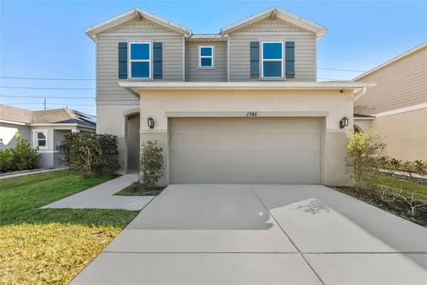 a front view of a house with a yard and garage