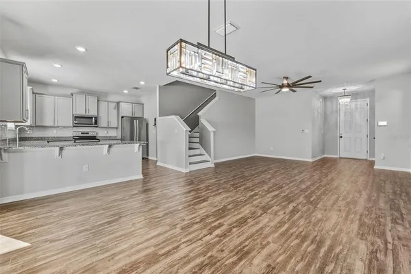 a view of a kitchen with a sink and dishwasher a refrigerator with wooden floor