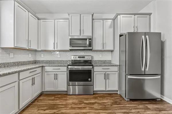a kitchen with a refrigerator sink and microwave