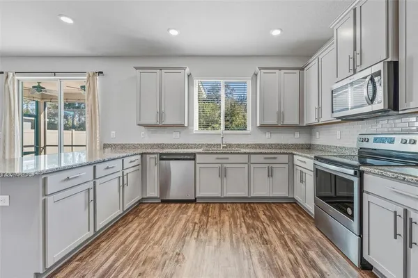 a kitchen with stainless steel appliances granite countertop a stove and a sink