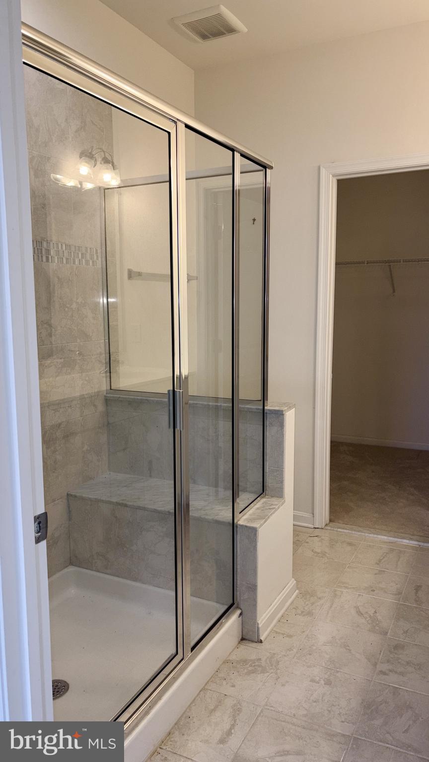 301 Arch Street Milton, DE 19968 - Photo 12 of 34 a bathroom with a glass shower door