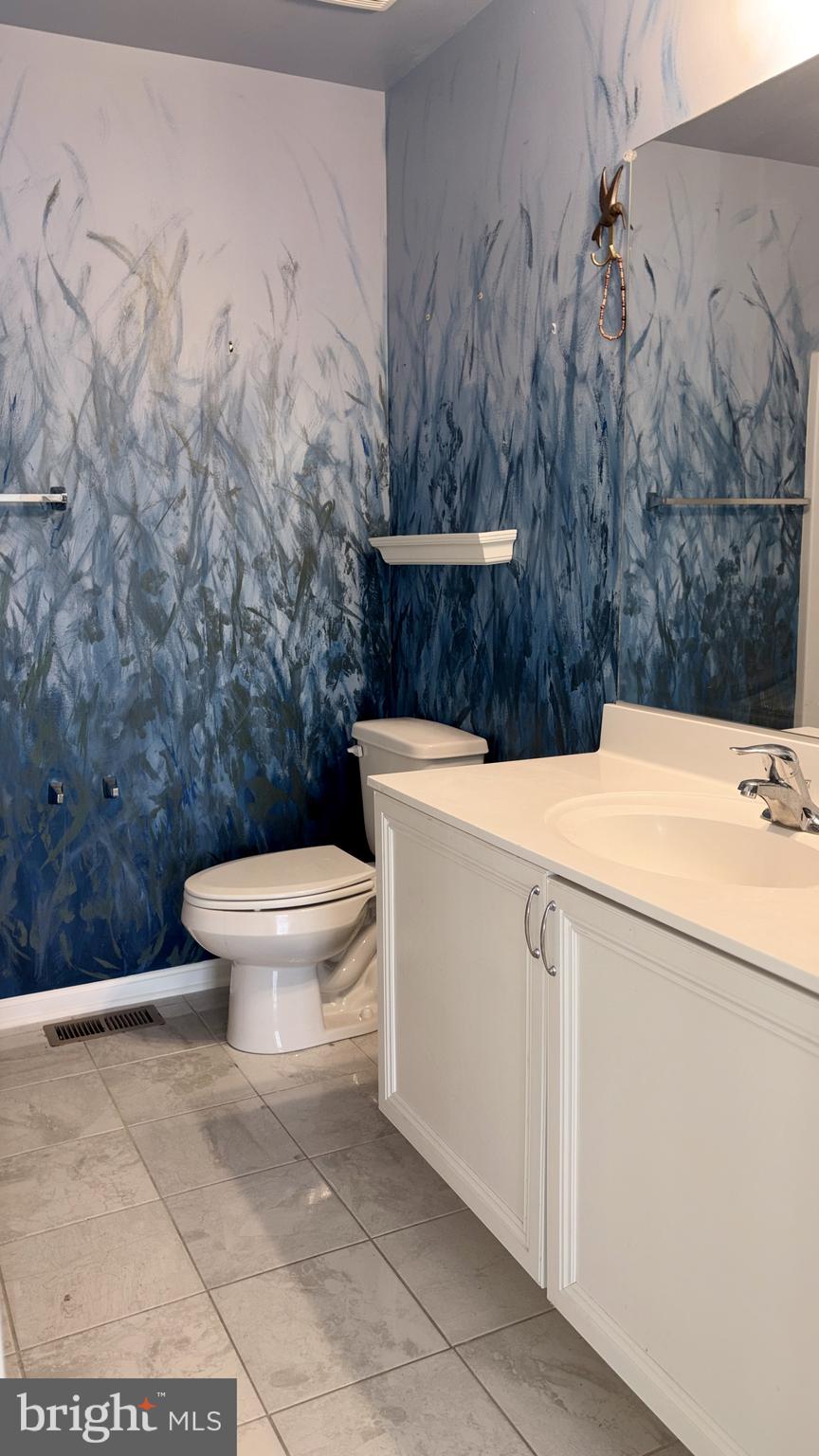 301 Arch Street Milton, DE 19968 - Photo 24 of 34 a bathroom with a sink a toilet and a mirror