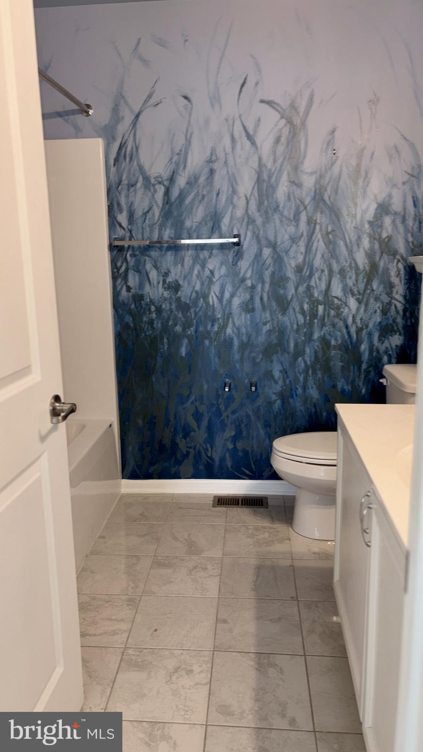 301 Arch Street Milton, DE 19968 - Photo 25 of 34 a bathroom with a toilet and a shower