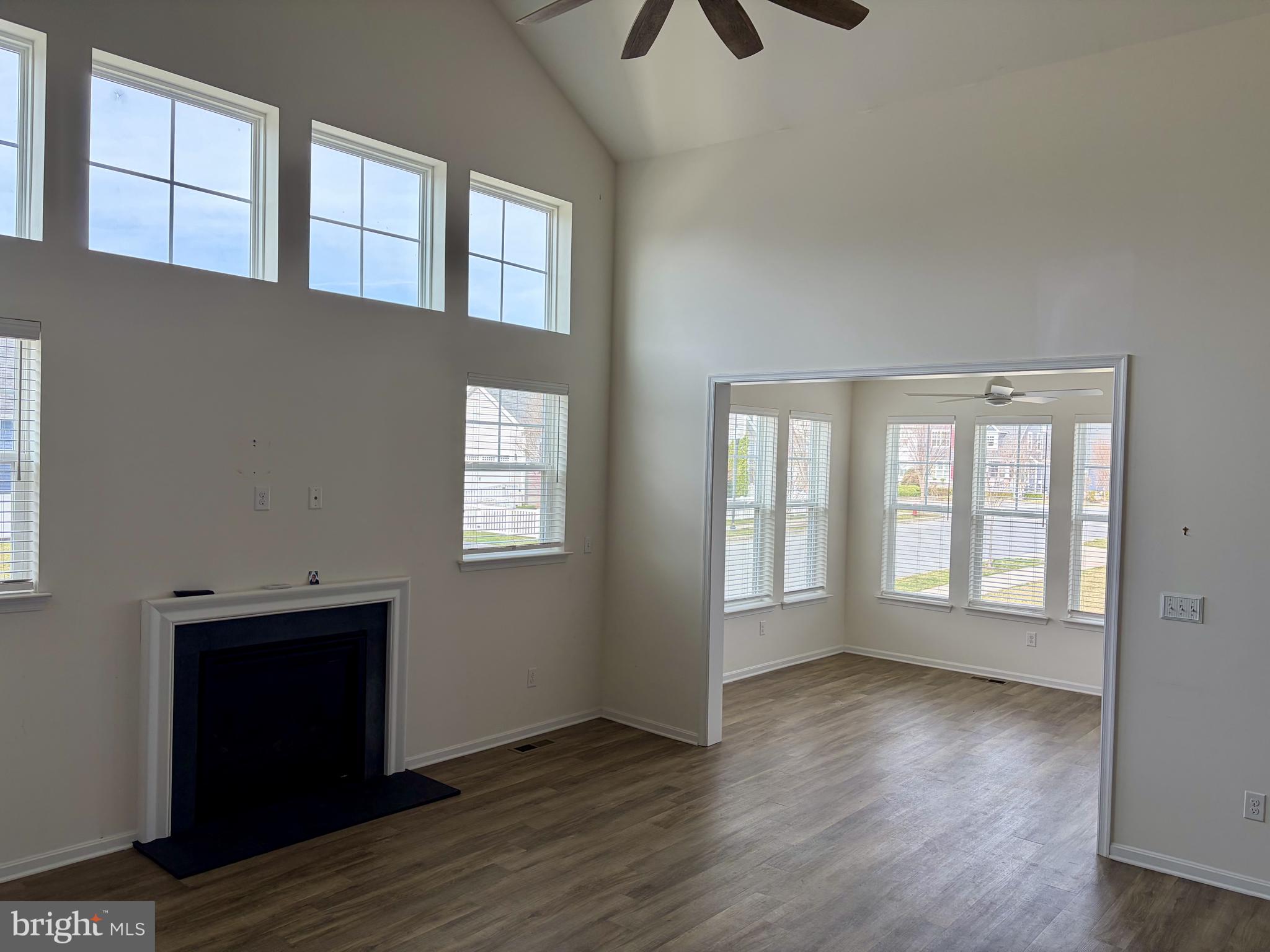 301 Arch Street Milton, DE 19968 - Photo 3 of 34 a view of an empty room with wooden floor and a window