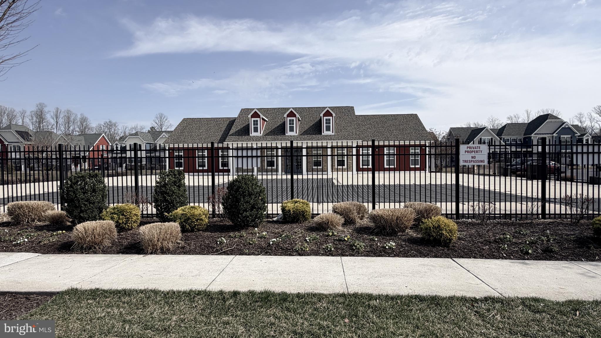 301 Arch Street Milton, DE 19968 - Photo 33 of 34 a view of a large building with a bench in front of house