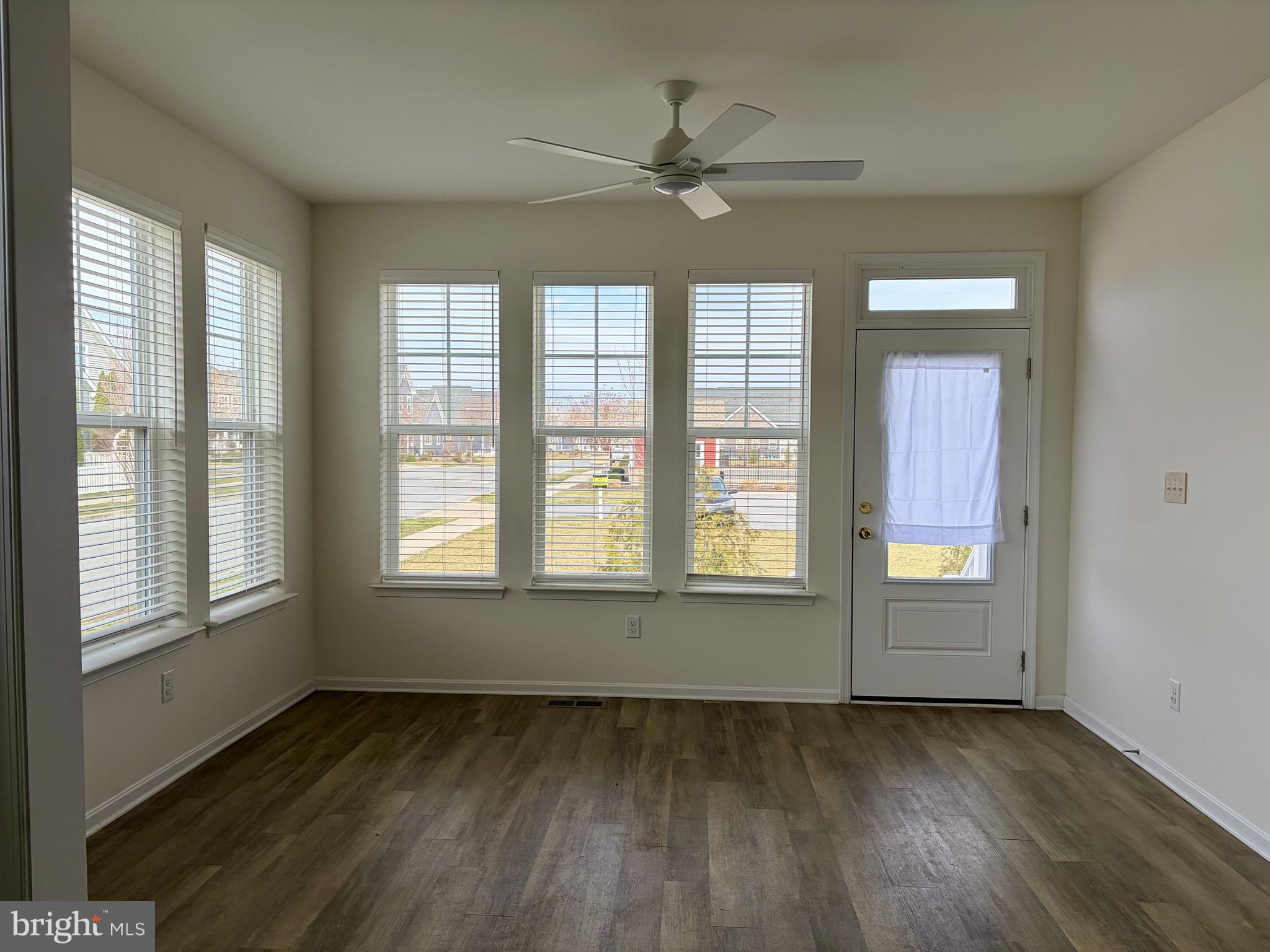 301 Arch Street Milton, DE 19968 - Photo 4 of 34 a view of an empty room with wooden floor and a window