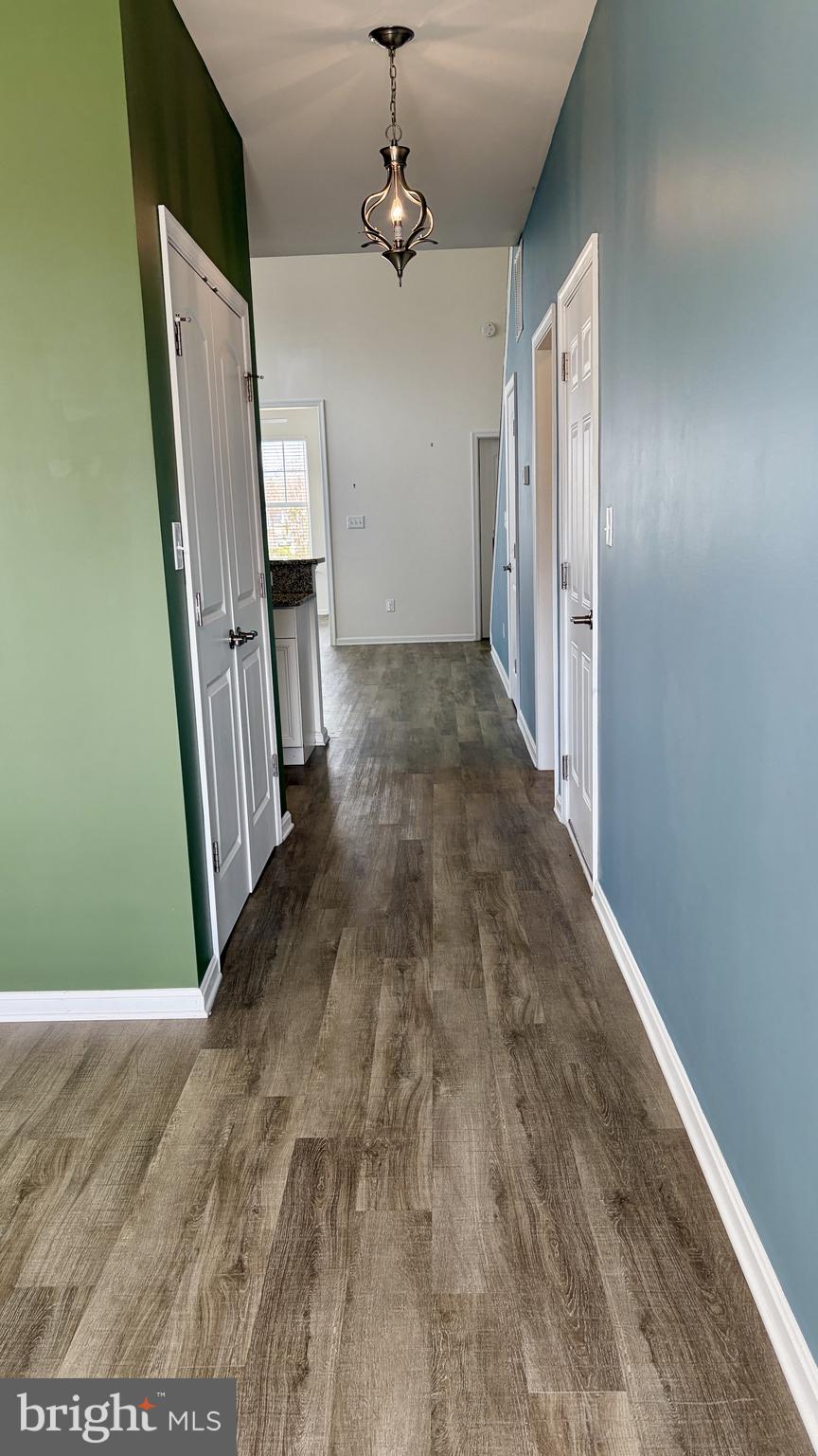 301 Arch Street Milton, DE 19968 - Photo 5 of 34 a view of a hallway with wooden floor and staircase