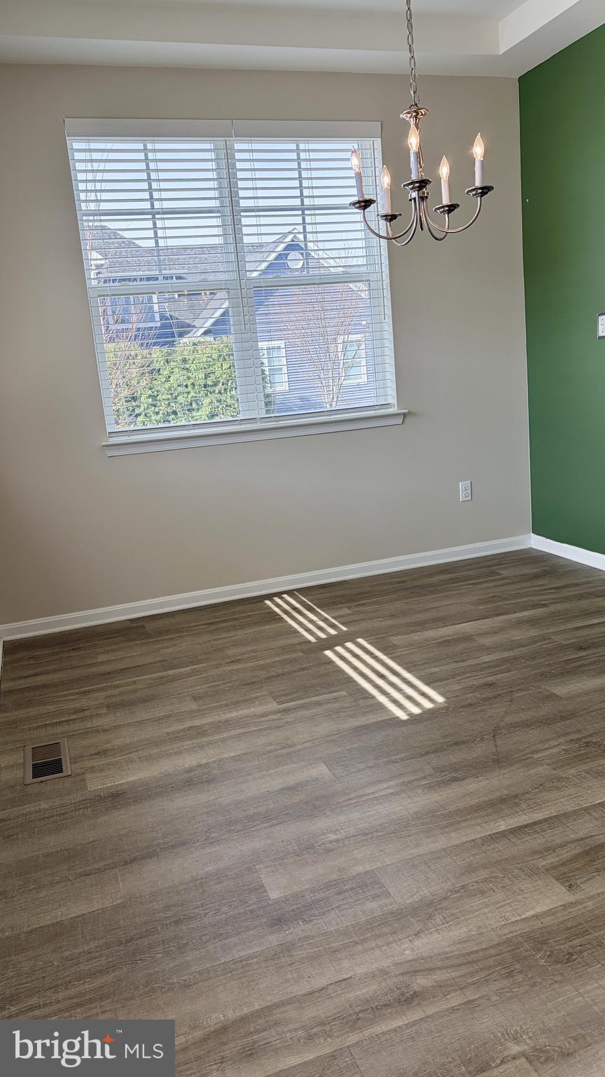 301 Arch Street Milton, DE 19968 - Photo 8 of 34 a view of a room with wooden floor and window