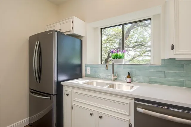 a kitchen with a sink and a refrigerator