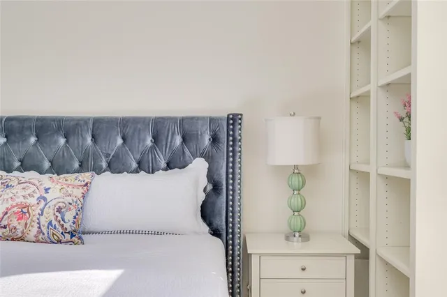 a living room with a couch and a potted plant