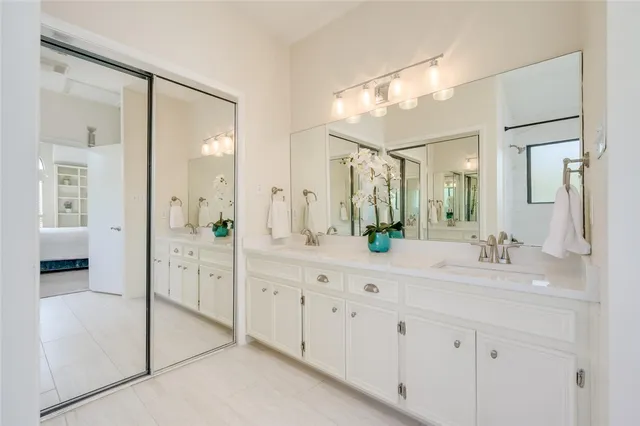 a spacious bathroom with double sink and shower