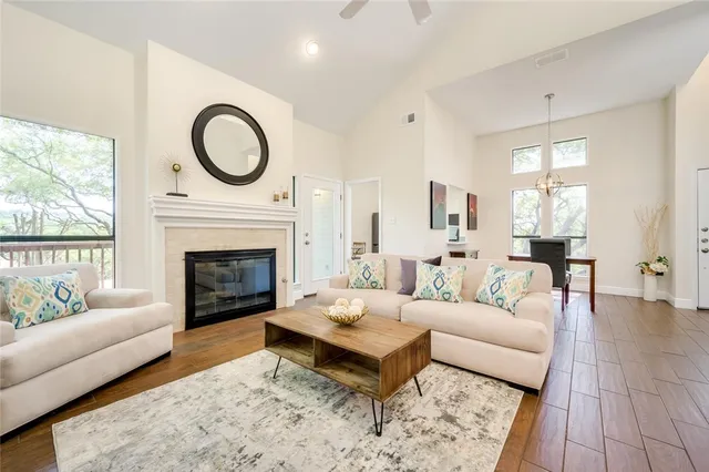 a living room with furniture a rug and a fireplace