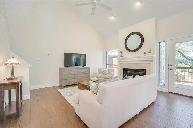 a living room with furniture a fireplace and a flat screen tv