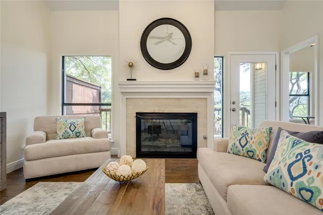 a living room with furniture a fireplace and window