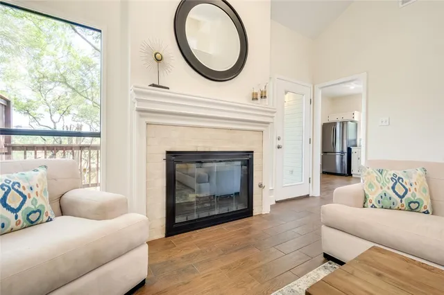 a living room with furniture a window and a fireplace