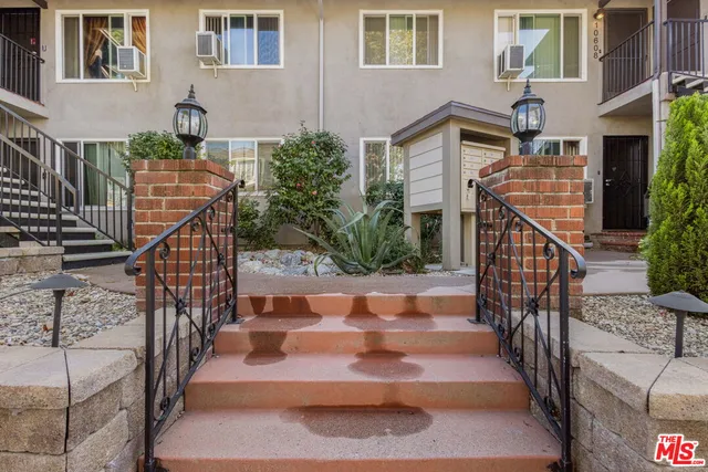 a view of stairs and a front view of a house