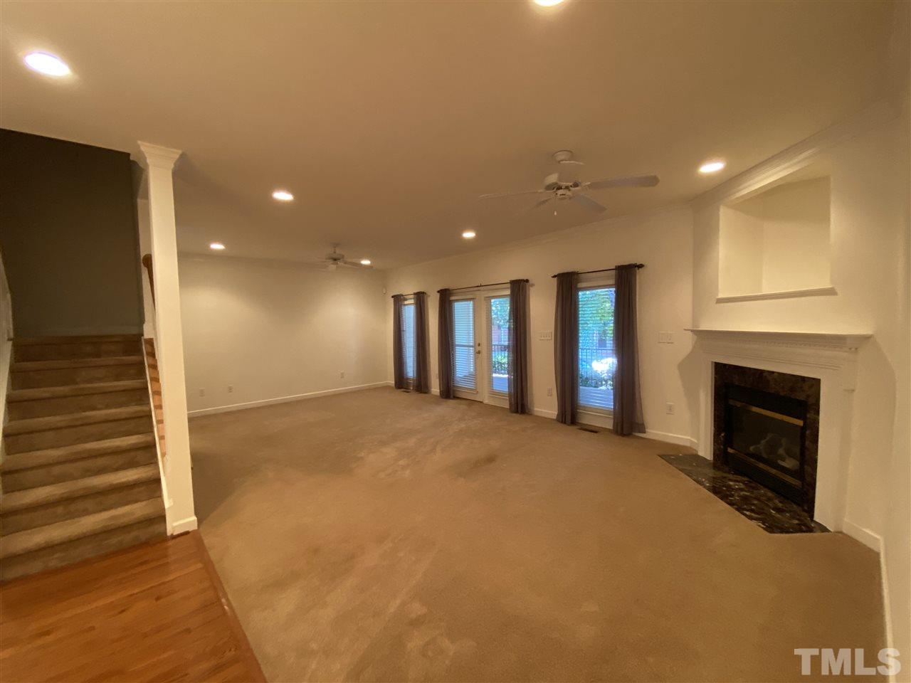 4606 Mistiflower Drive Raleigh, NC 27606 - Photo 2 of 9 a view of an empty room with a fireplace and a window