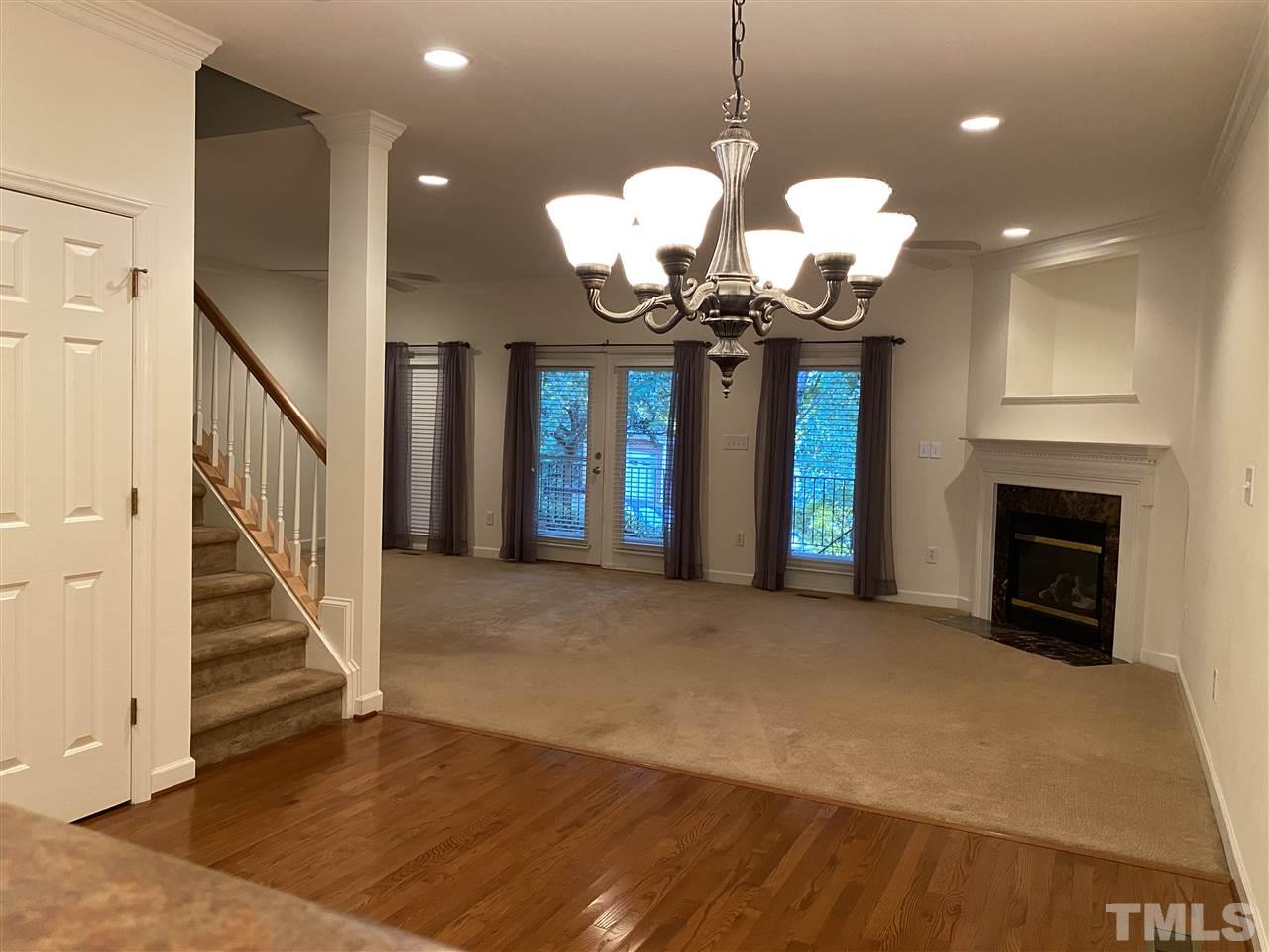 4606 Mistiflower Drive Raleigh, NC 27606 - Photo 4 of 9 a view of a room with a chandelier and fireplace