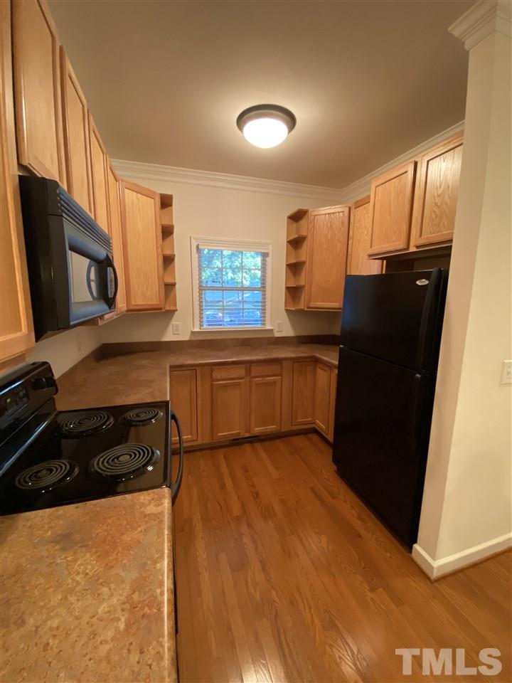 4606 Mistiflower Drive Raleigh, NC 27606 - Photo 5 of 9 a kitchen with a refrigerator and a stove