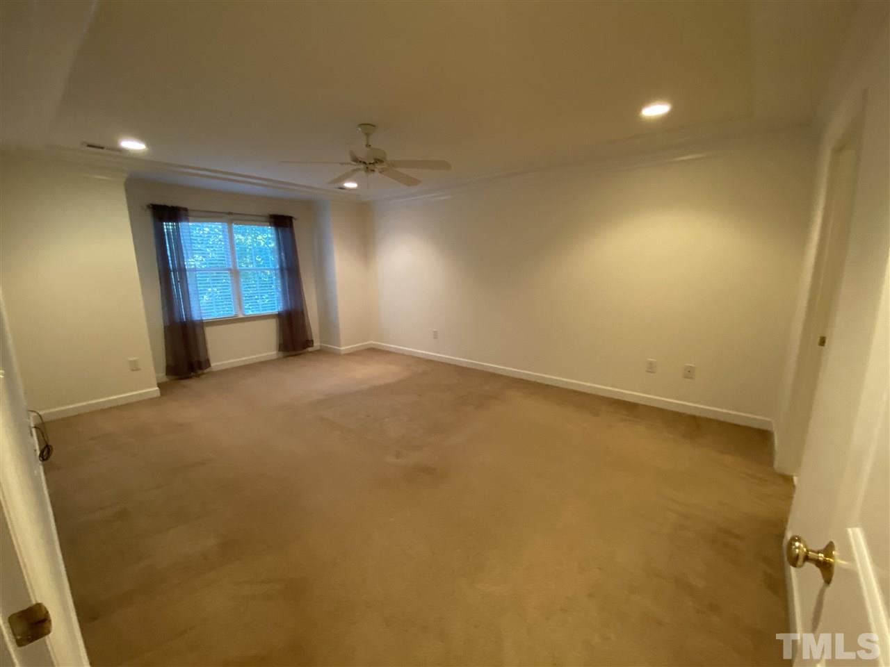 4606 Mistiflower Drive Raleigh, NC 27606 - Photo 7 of 9 an empty room with windows and fireplace