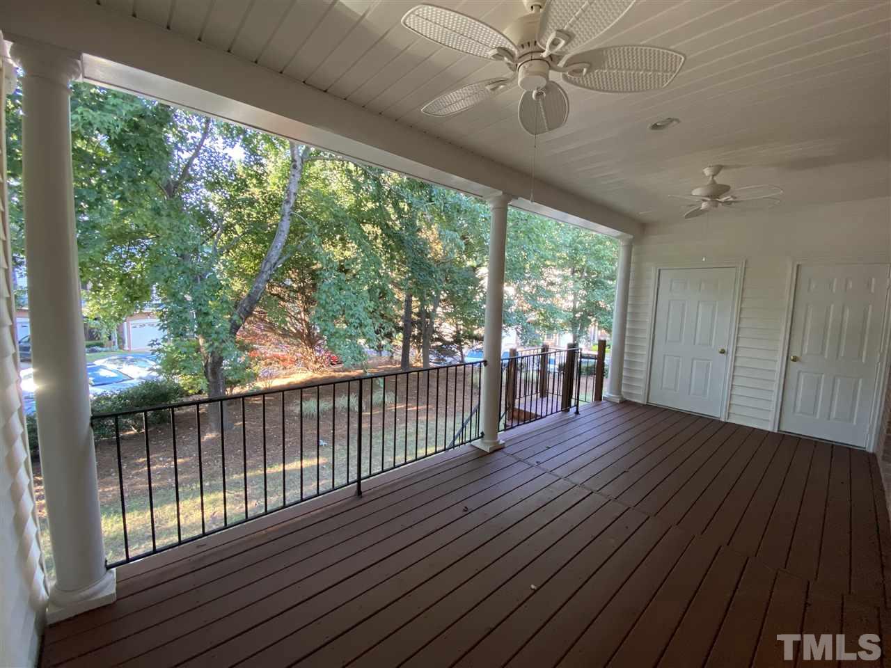 4606 Mistiflower Drive Raleigh, NC 27606 - Photo 8 of 9 a view of a porch with wooden floor