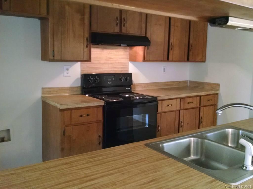 21141 Pine Ridge Drive Cornelius, NC 28031 - Photo 2 of 15 a kitchen with granite countertop a sink stainless steel appliances and cabinets