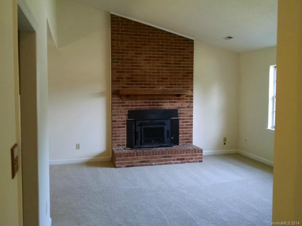 21141 Pine Ridge Drive Cornelius, NC 28031 - Photo 5 of 15 a view of empty room with a fireplace