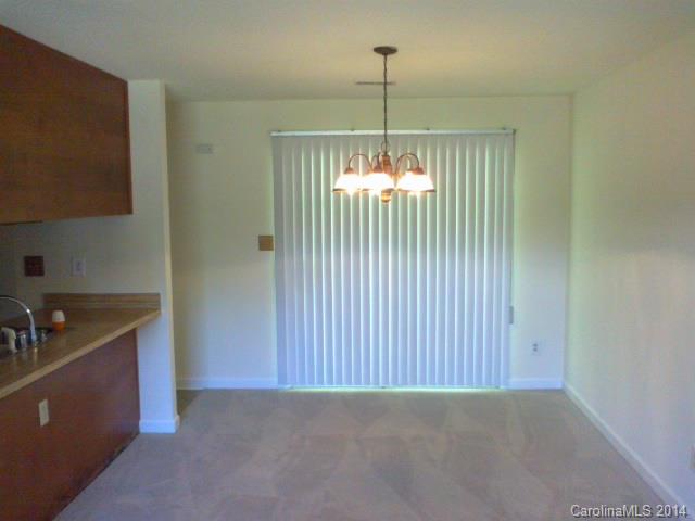 21141 Pine Ridge Drive Cornelius, NC 28031 - Photo 7 of 15 a view of an empty room with window and chandelier fan