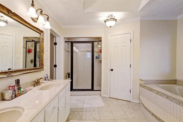a spacious bathroom with a tub sink and mirror