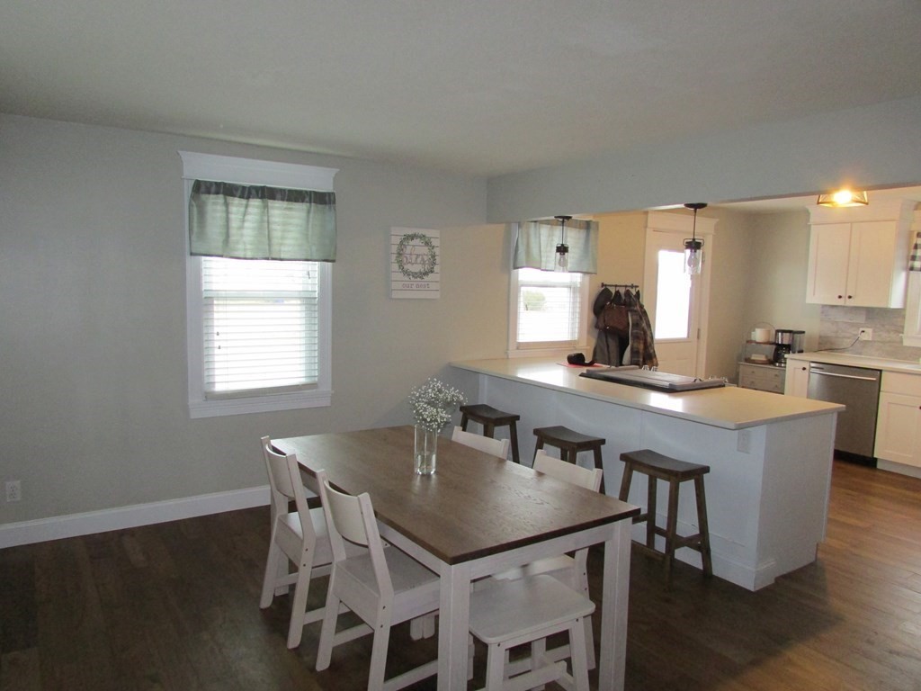 315 Hartwick Street Springfield, MA 01108 - Photo 13 of 40 a kitchen with a table chairs a sink dishwasher window and cabinets