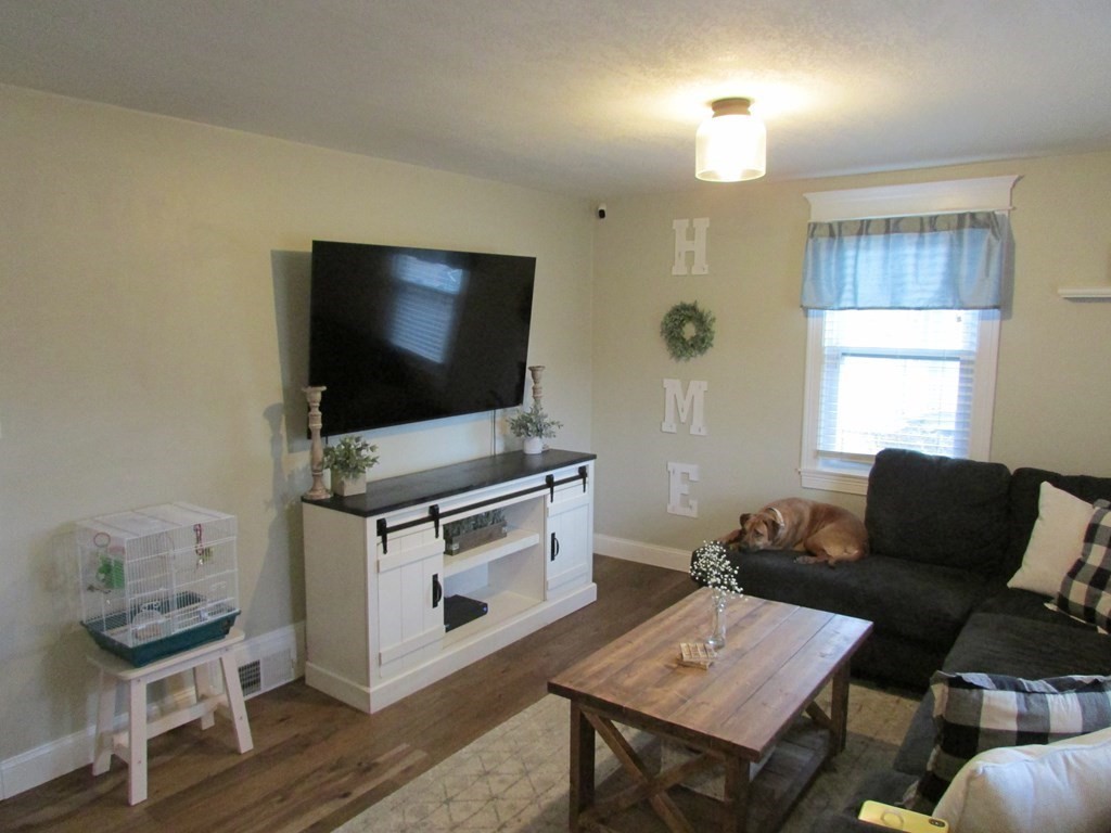 315 Hartwick Street Springfield, MA 01108 - Photo 17 of 40 a living room with furniture and a flat screen tv