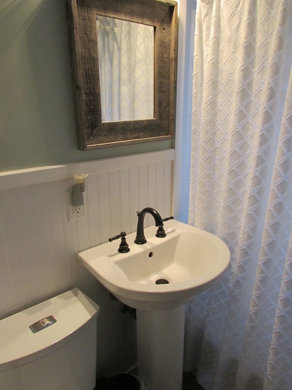315 Hartwick Street Springfield, MA 01108 - Photo 18 of 40 a bathroom with a sink and a mirror