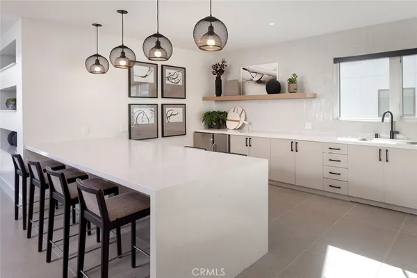 a kitchen with table chairs cabinets and stainless steel appliances