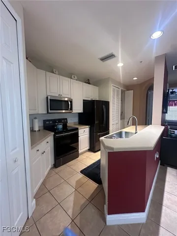 a kitchen with stainless steel appliances granite countertop a sink stove microwave and refrigerator
