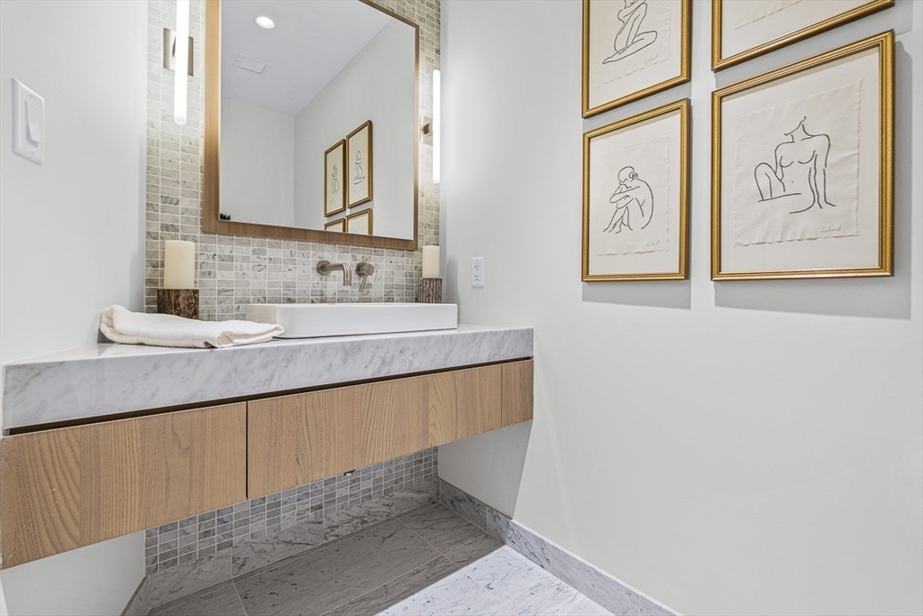 40 Trinity Place, Unit 32A Boston, MA 02116 - Photo 4 of 32 a bathroom with a sink and a mirror