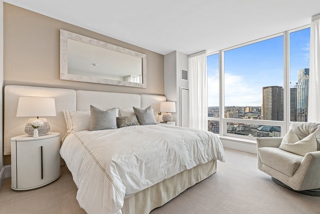 40 Trinity Place, Unit 32A Boston, MA 02116 - Photo 5 of 32 a bedroom with bed and a large window