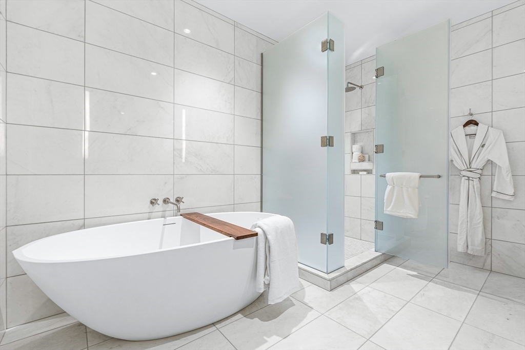 40 Trinity Place, Unit 32A Boston, MA 02116 - Photo 7 of 32 a bathroom with a tub and shower