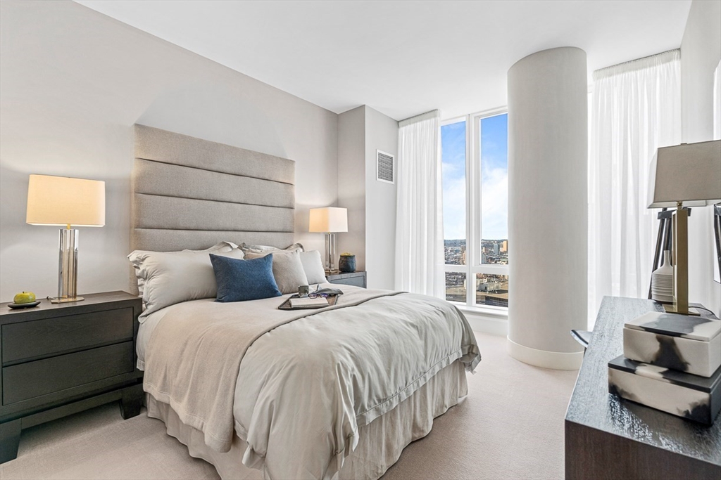 40 Trinity Place, Unit 32A Boston, MA 02116 - Photo 9 of 32 a bedroom with a bed flat screen tv and a large window
