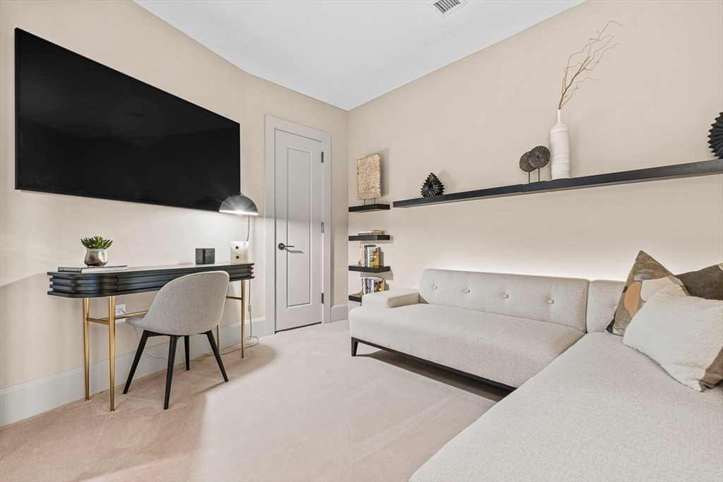 40 Trinity Place, Unit 32A Boston, MA 02116 - Photo 10 of 32 a living room with furniture and a flat screen tv