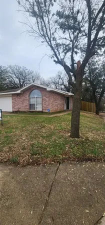a view of a large house with a yard and large tree