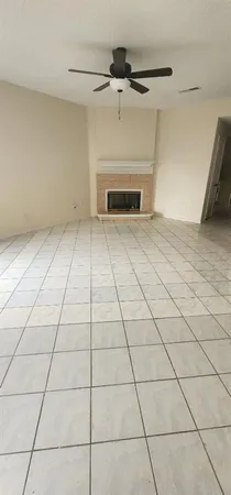 a view of empty room with a fireplace