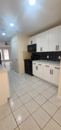 a kitchen with stainless steel appliances granite countertop a sink and a stove