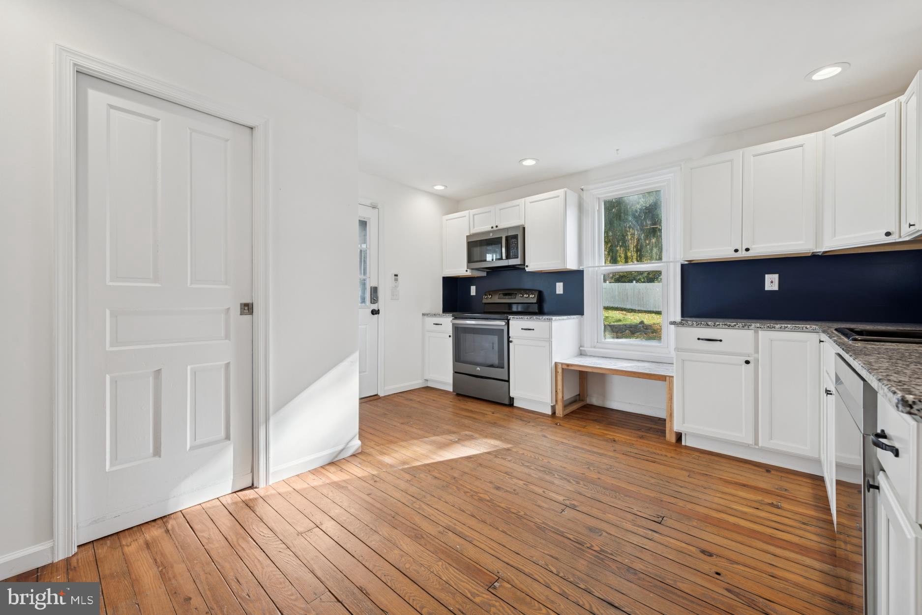 92 Embreeville Road Downingtown, PA 19335 - Photo 11 of 30 a kitchen with white cabinets and stainless steel appliances